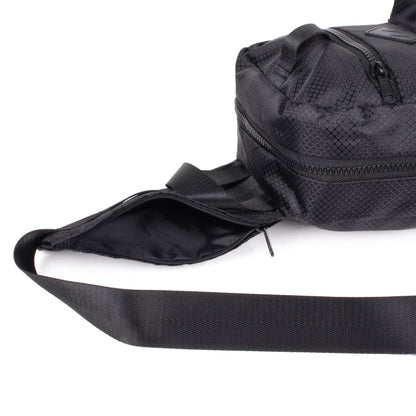 Sport crossbody sling bag in black mesh pattern with wide adjustable strap and multiple zippered compartments