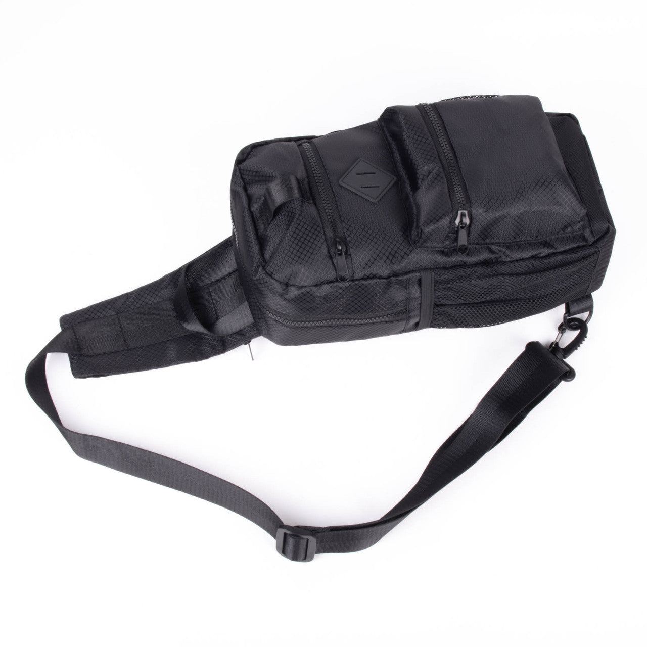 Black sport crossbody sling bag with mesh panels and multiple zippered compartments for tactical use