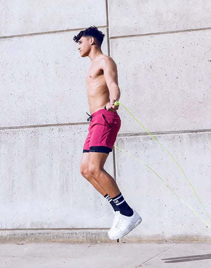 A vibrant red spr max short with black trim and drawstring waistband ideal for athletic use