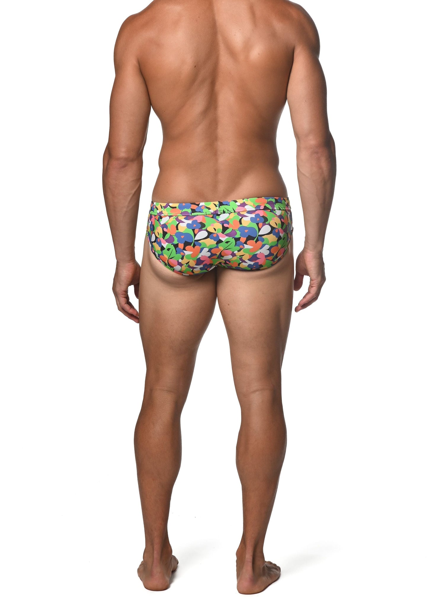 Spring green abstract freestyle swim brief vibrant multicolored swim trunks with playful abstract shapes in green blue orange and purple