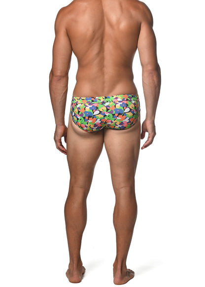 Spring green abstract freestyle swim brief vibrant multicolored swim trunks with playful abstract shapes in green blue orange and purple