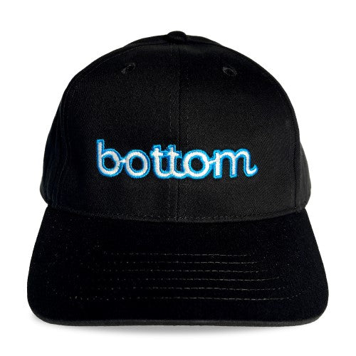 Black baseball cap with glowing blue embroidered bottom logo in spunky monkee cap design