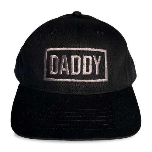 Black snapback cap spunky monkee cap daddy with silver embroidered daddy text in a rectangular border