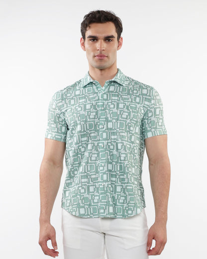 A man wearing a light green and white geometric patterned short-sleeve squares print open knit shirt