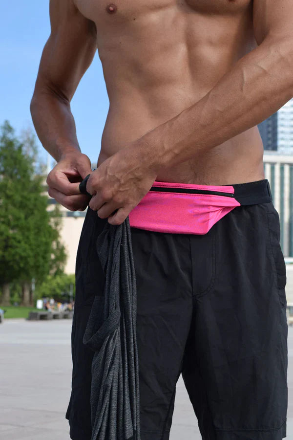 Bright pink ssbag runing belt athletic waist pouch with black trim and adjustable strap worn around the midsection
