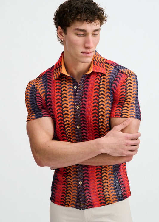 Short-sleeve button-down shirt featuring an orange, red, and blue chevron pattern and an orange collar.