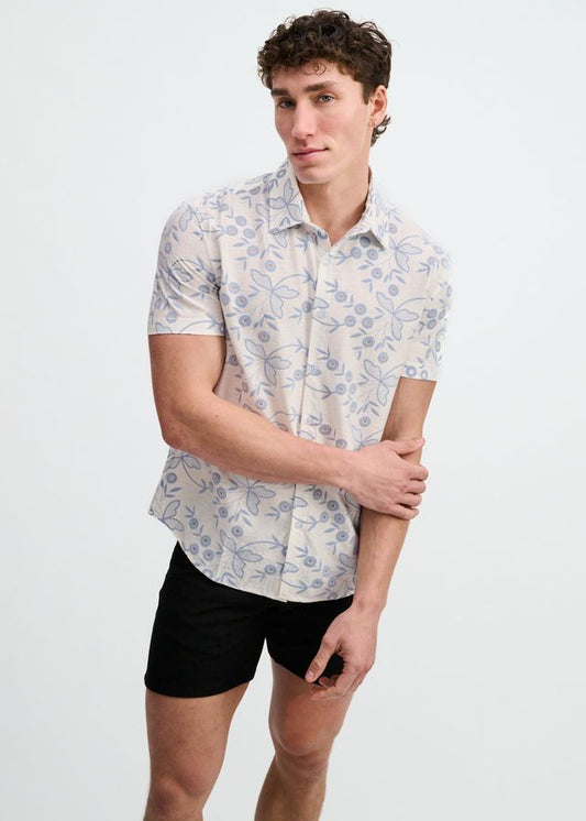 Short-sleeve button-down shirt in off-white featuring a light blue floral and leaf print.