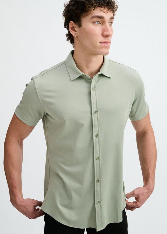 Short-sleeve button-down shirt in laurel green with a pointed collar, worn against a plain white background.