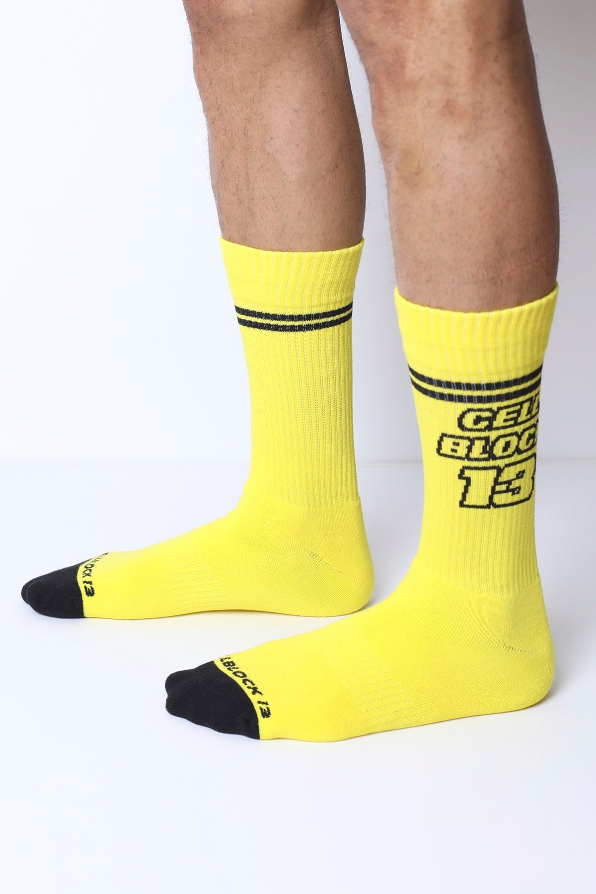 Starter crew socks in bright yellow with black toe caps and stripes featuring bold gelb block 13 text on the side