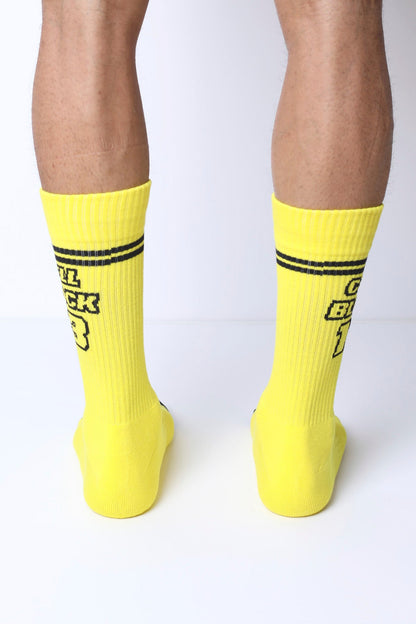 Starter crew socks in bright yellow with black text and two horizontal stripes near the top for casual wear
