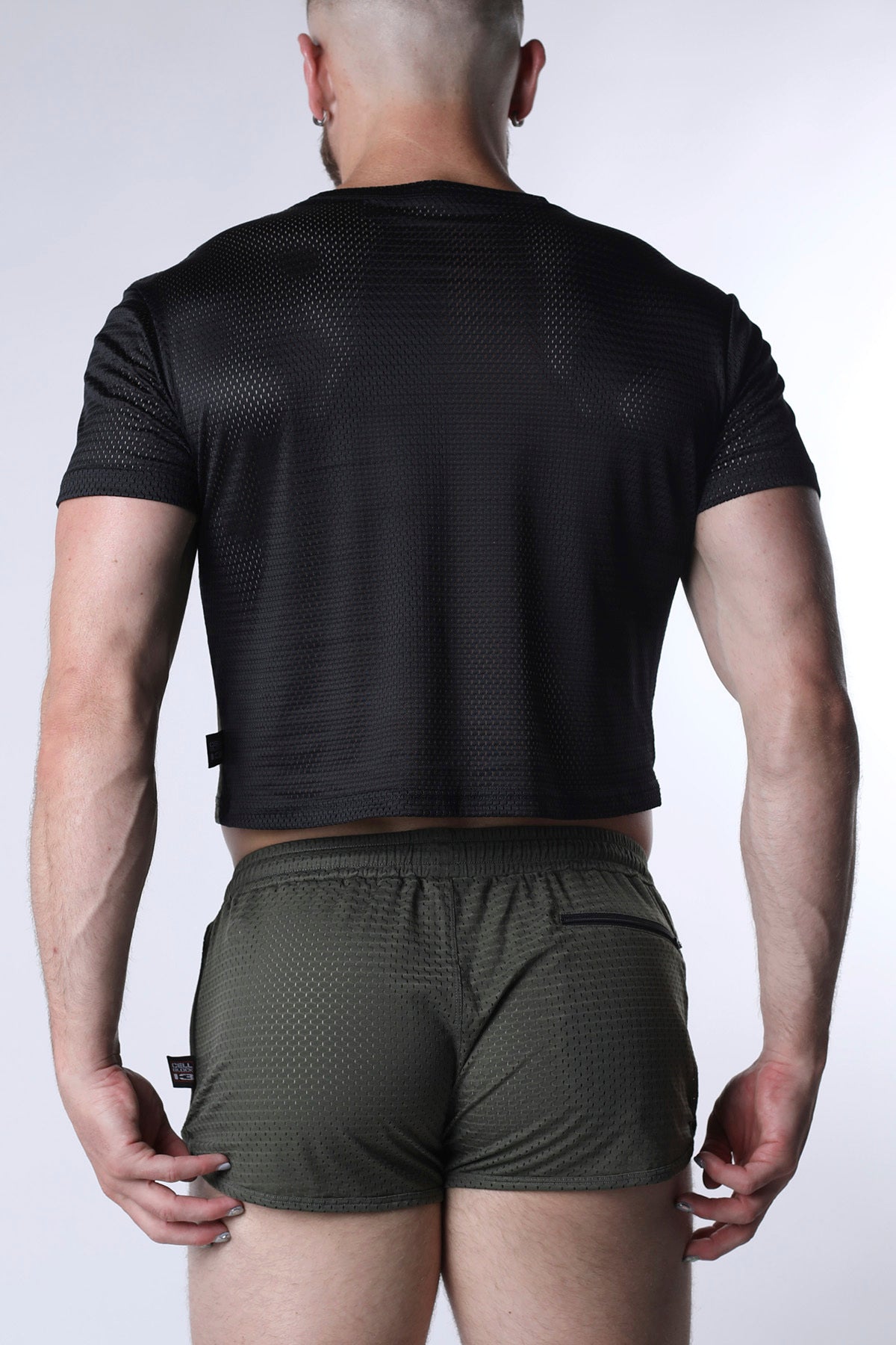 Starter mesh crop top black short-sleeved crop top with breathable textured fabric and subtle perforations on the back