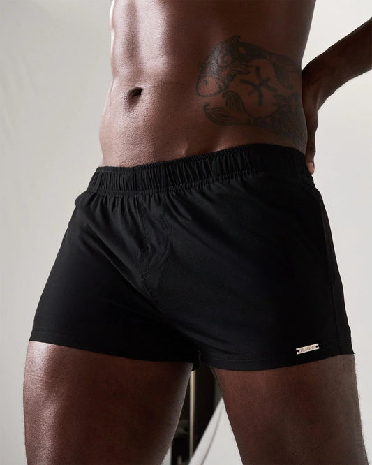 Statement swim short black athletic shorts with elastic waistband and small metallic logo on lower right leg