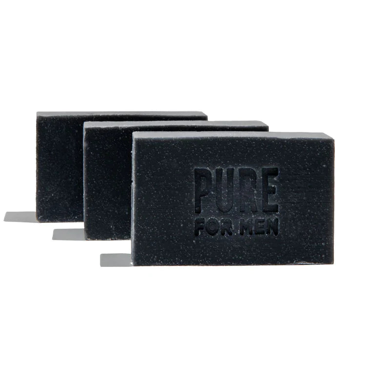 Three rectangular black bars of pure for men soap embossed in bold font from the stay ready bar product line