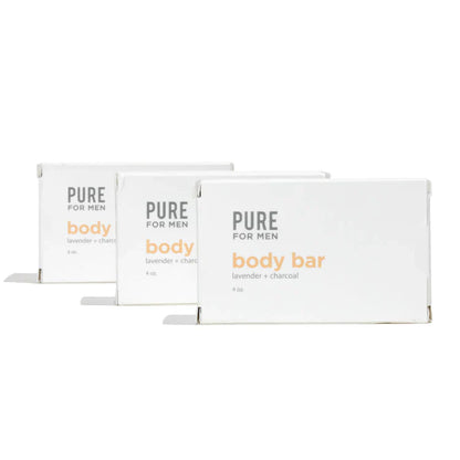 Three white rectangular boxes of pure for men lavender and charcoal body bar labeled stay ready bar in orange and gray text