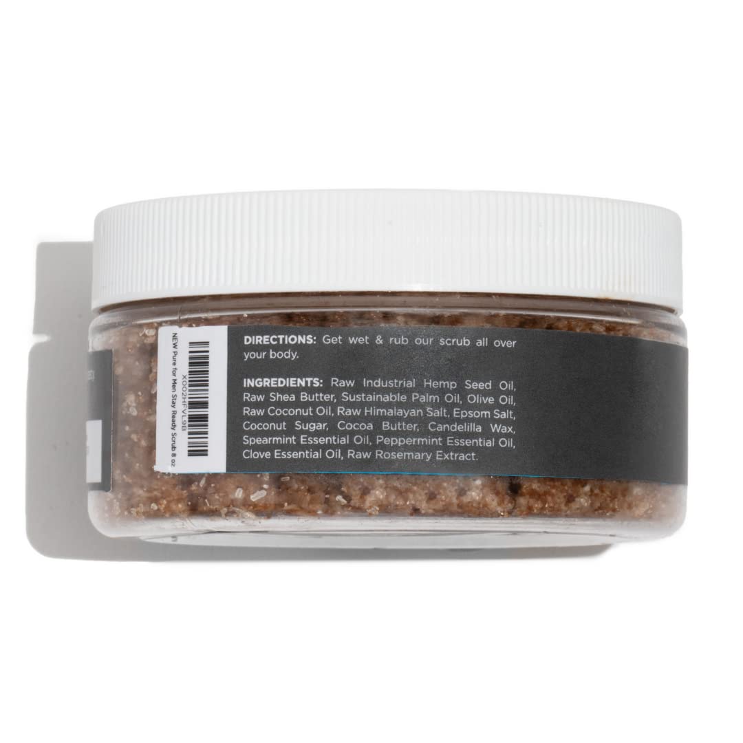 A clear plastic jar with white ribbed lid contains brown granular body scrub stay ready scrub with ingredient label
