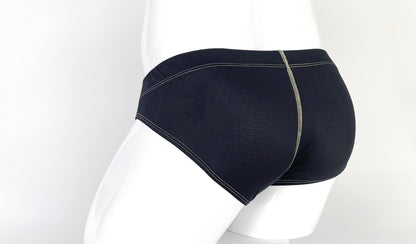 Black textured pouch brief worn on a mannequin, featuring prominent yellow contrast stitching and back seam detail.