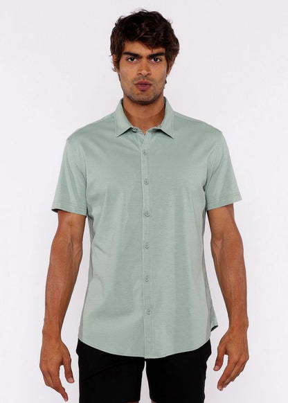 A light green stretch knit shirt with short sleeves and classic collar featuring neatly stitched seams