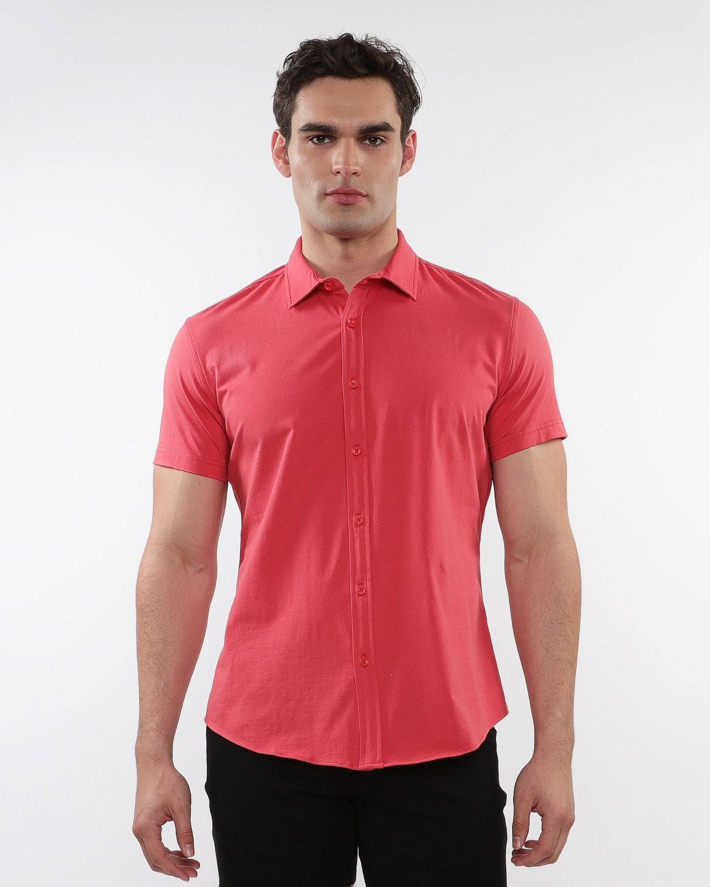 A coral stretch knit shirt with short sleeves classic collar and crisp button-down design