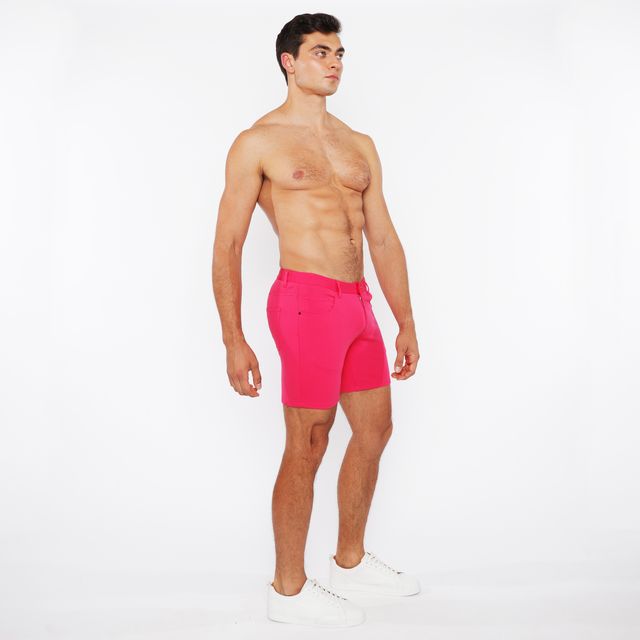 Bright pink stretch knit shorts with tailored fit and belt loops for athletic and casual wear