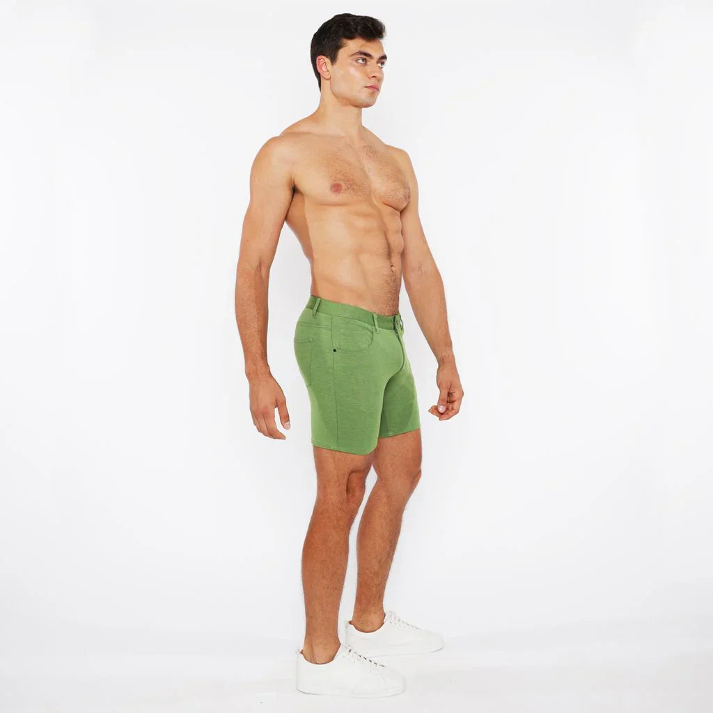 Green stretch knit athletic shorts with a fitted cut and visible stitching details for active wear