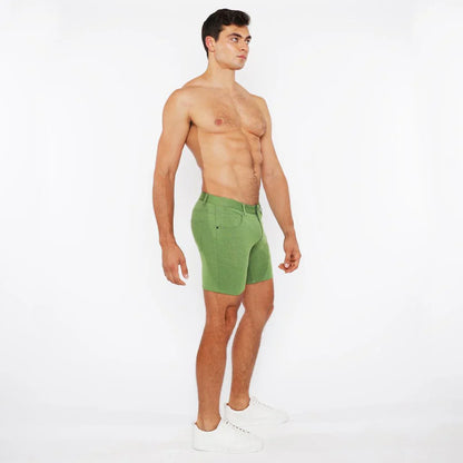 Green stretch knit athletic shorts with a fitted cut and visible stitching details for active wear