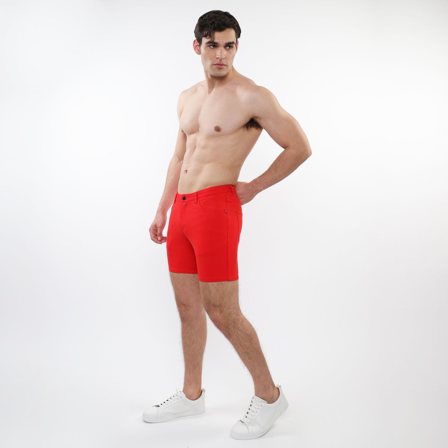 Bright red stretch knit shorts for men with a tailored fit, classic five-pocket design, and button closure