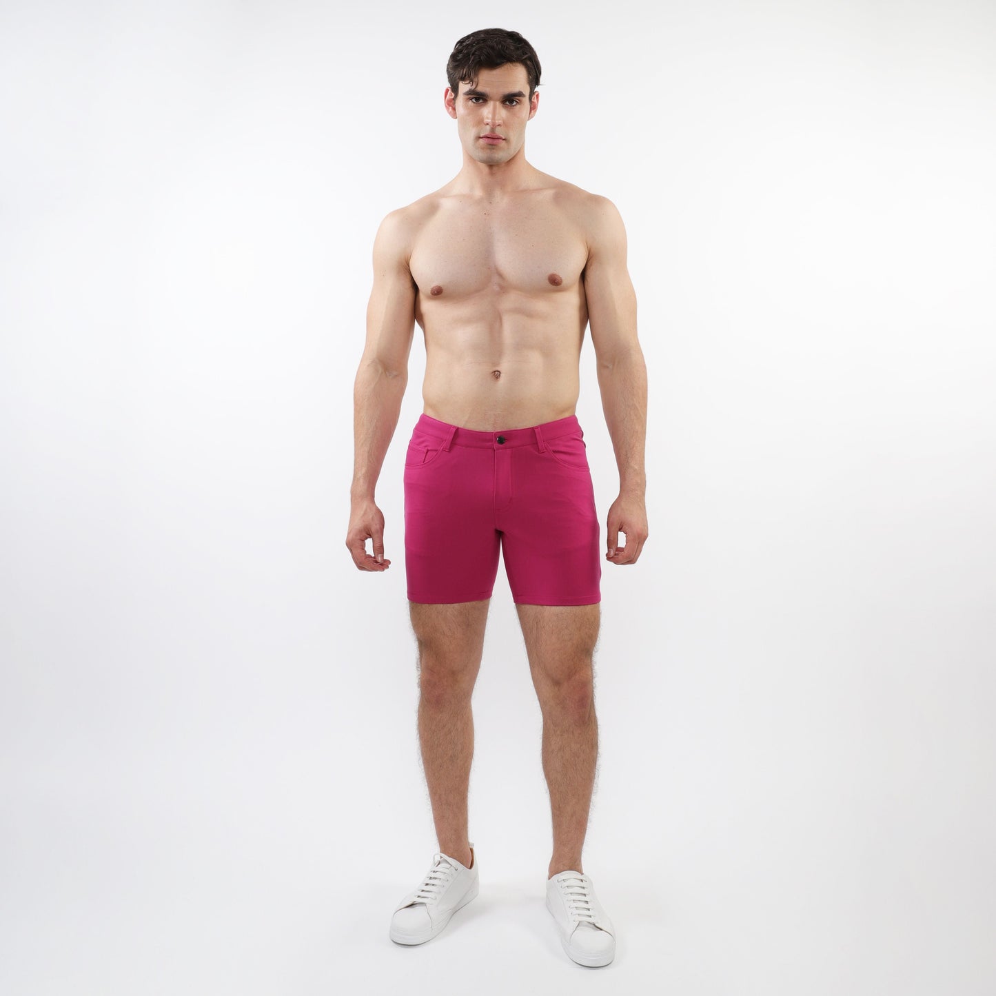 A pair of vibrant fuchsia stretch knit shorts with form-fitting modern design and subtle stitching details