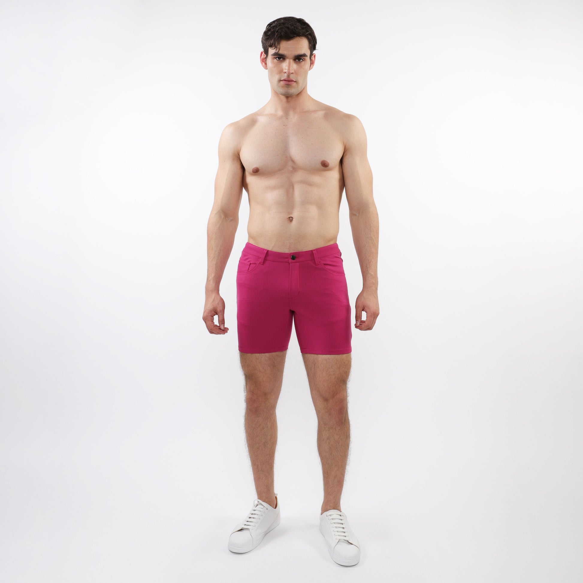 A pair of vibrant fuchsia stretch knit shorts with form-fitting modern design and subtle stitching details
