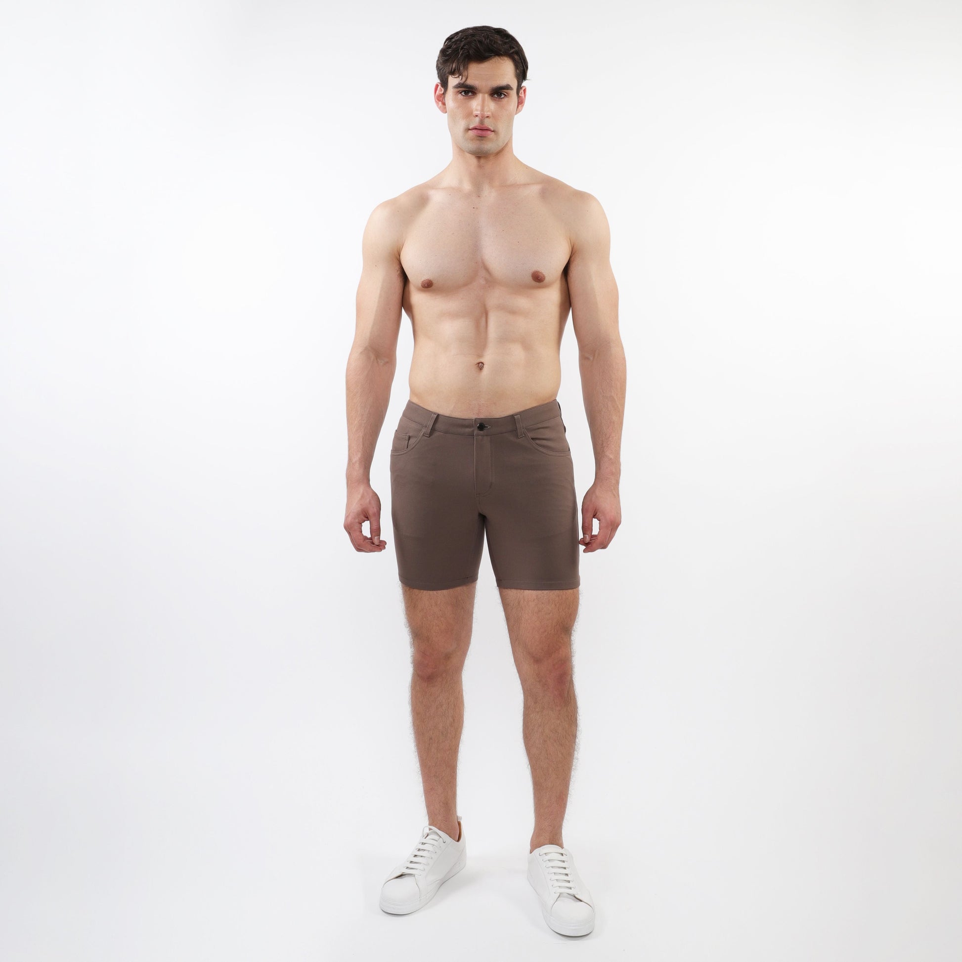 A pair of slim-fit dark brown stretch knit shorts with a modern design and subtle stitching details