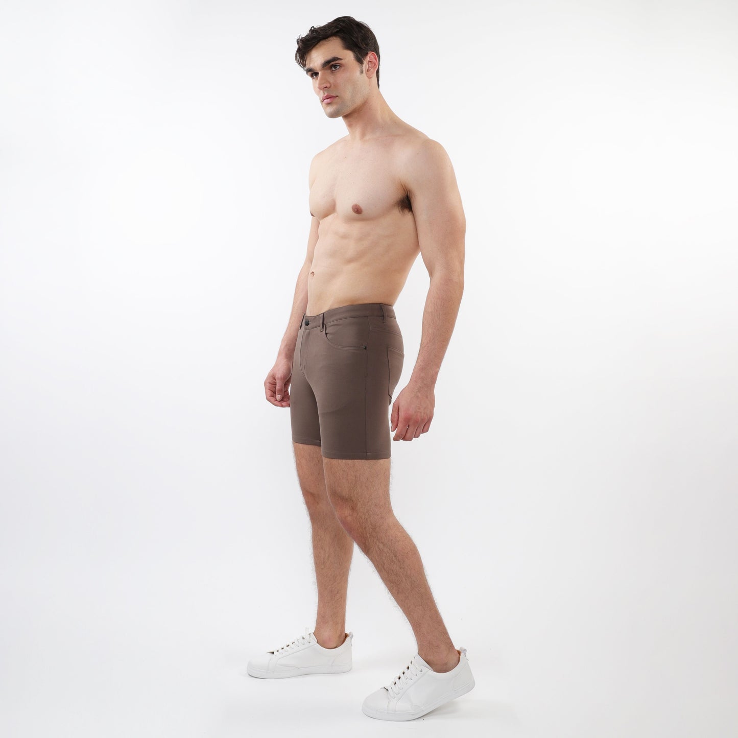 Brown stretch knit shorts with a form-fitting design and subtle stitching details showing the back side