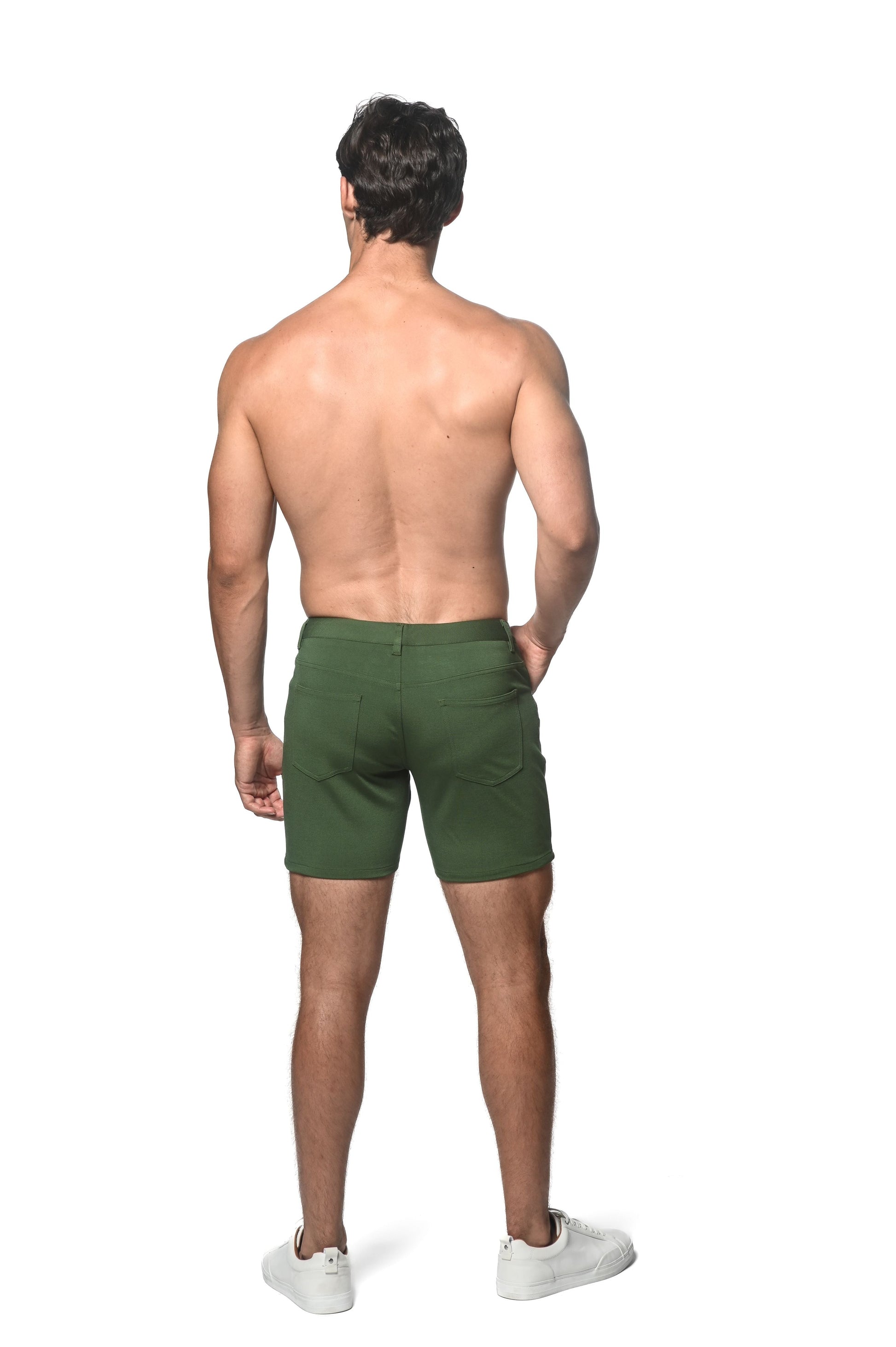 Dark green stretch knit shorts with classic design and visible back pockets shown from the back side