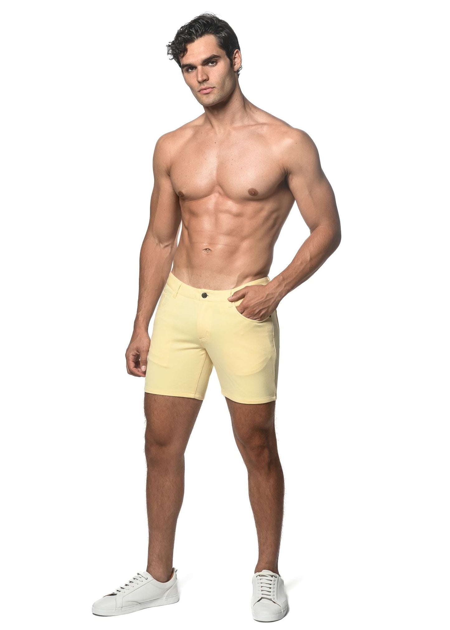 A pair of pale yellow stretch knit shorts with a single button closure and side pockets for a comfortable fit