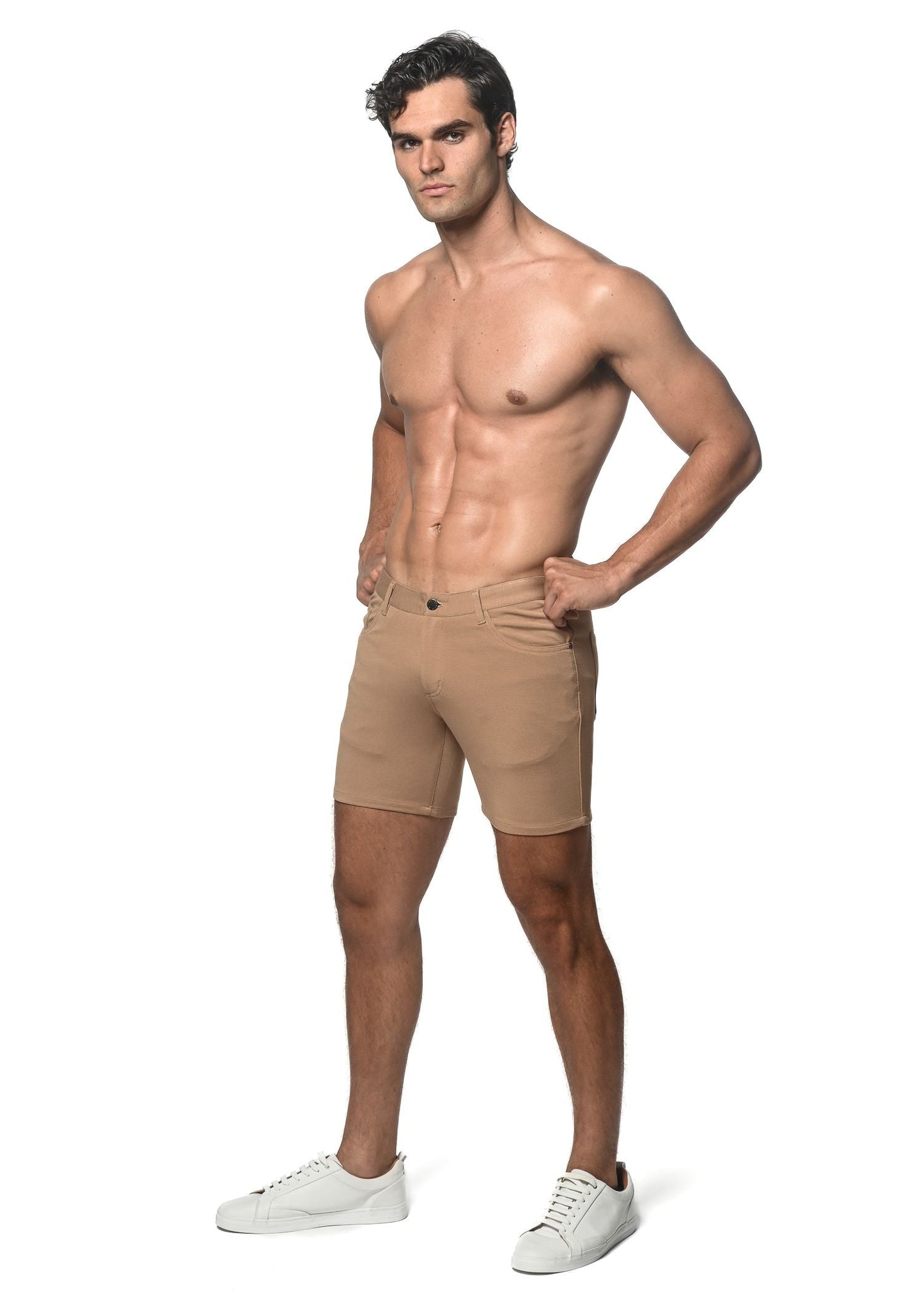 Beige stretch knit shorts with tailored fit and classic five-pocket design for athletic use
