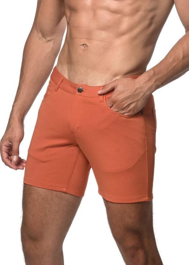 Orange stretch knit athletic shorts with button closure and side pockets for comfortable activewear use