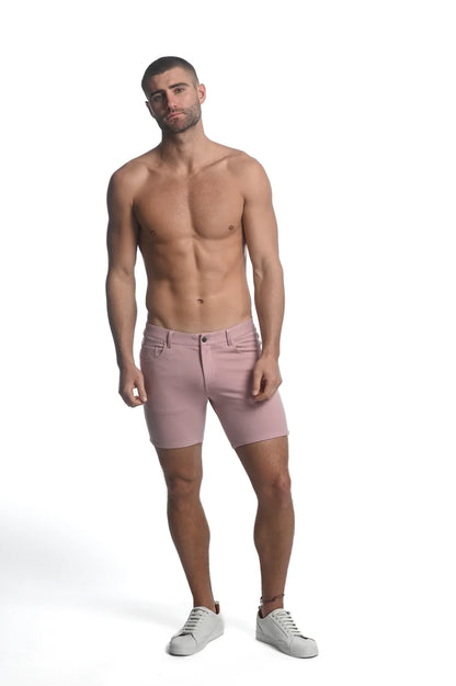 A pair of men’s pink stretch knit shorts with tailored fit and classic five-pocket design