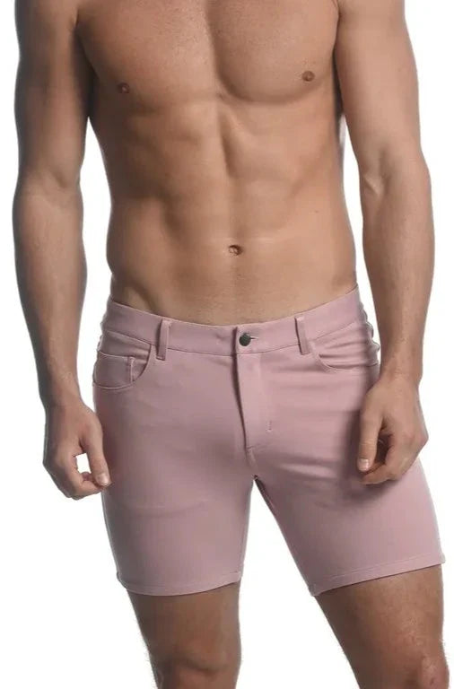 A pair of pink stretch knit men’s denim shorts with classic five-pocket design and button closure