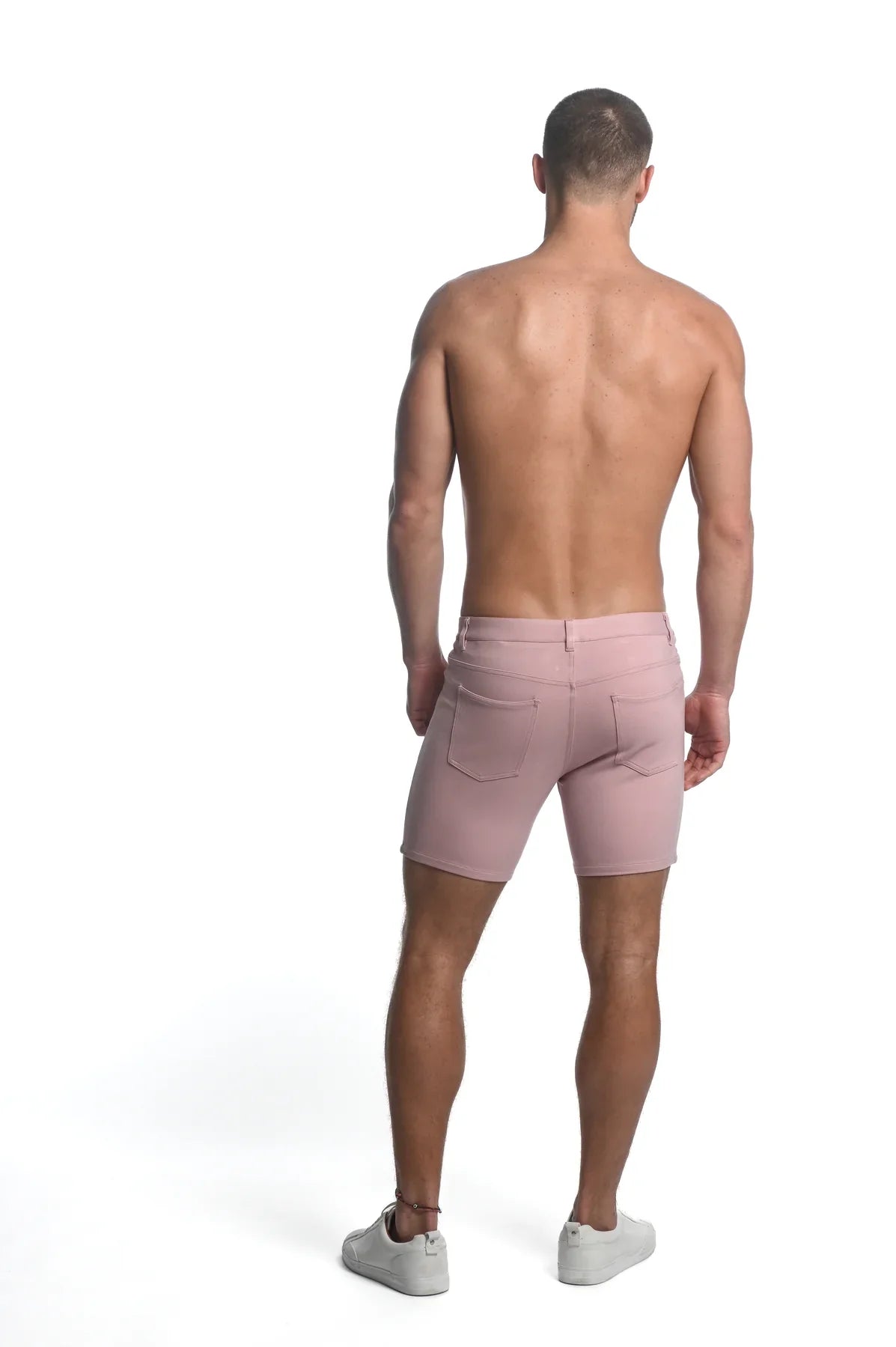 A pair of men’s pink stretch knit denim shorts with a classic five-pocket design and belt loops