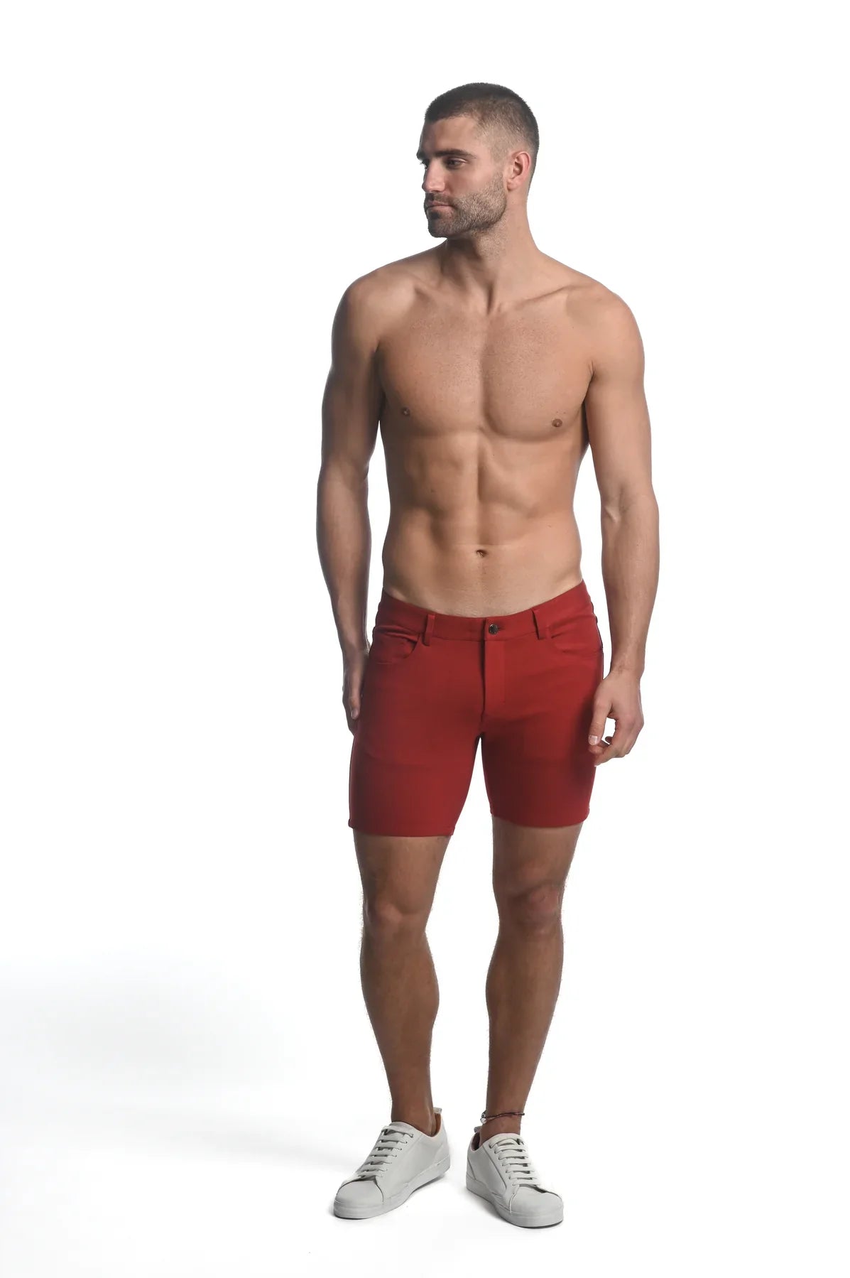 Red stretch knit shorts for men with a classic fit and button closure ideal for casual wear