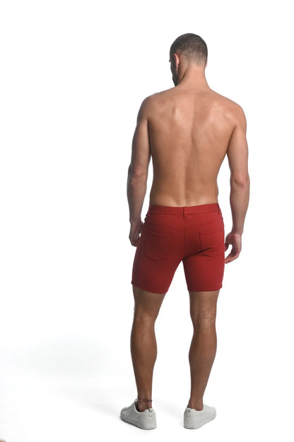 Red stretch knit short athletic shorts with tailored fit and visible back pockets shown from the back side