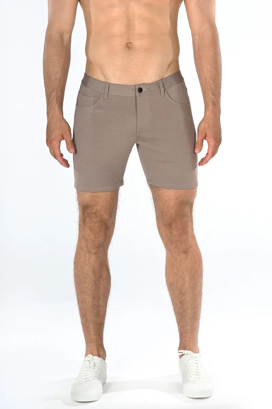 Beige stretch knit shorts with sleek modern design and subtle stitching details for versatile casual wear