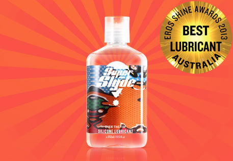 Clear plastic bottle of superslyde silicone lubricant with a white cap and colorful label featuring cartoon characters
