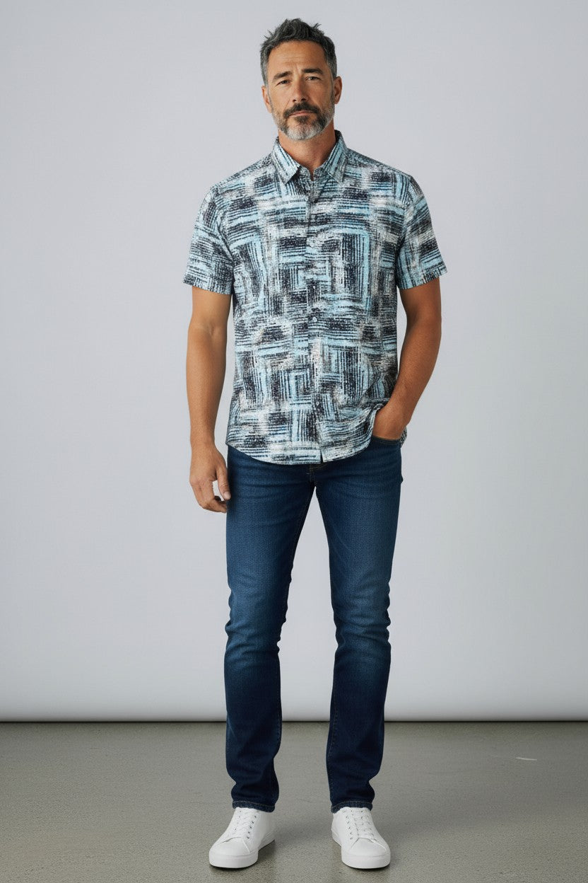 A man wearing a suslo crinkled fabric short-sleeved shirt with an abstract gray and white geometric pattern