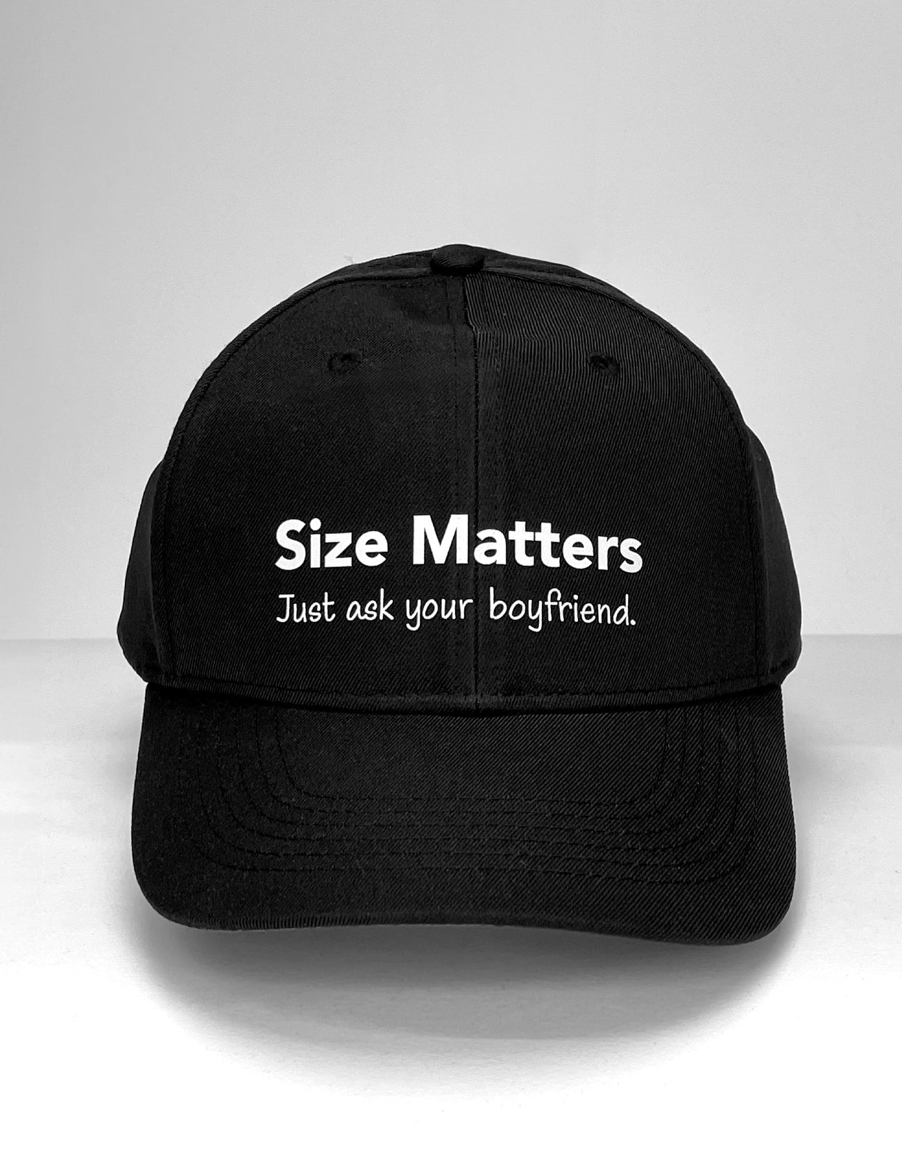 Black baseball cap with "Size Matters. Just ask your boyfriend." printed in white text.