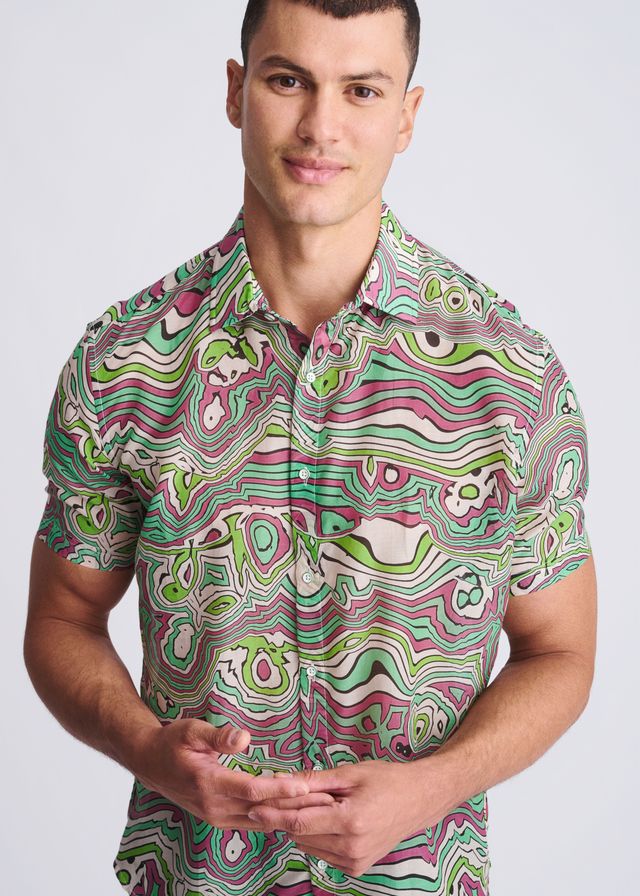 A vibrant short-sleeved lightweight cotton silk shirt with a psychedelic green pink and white swirl pattern