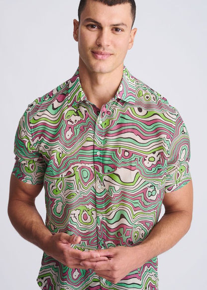 A vibrant short-sleeved lightweight cotton silk shirt with a psychedelic green pink and white swirl pattern