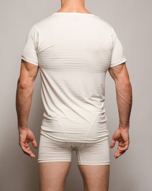 A sleek form-fitting white seamless active nylon t-shirt with short sleeves and a rounded neckline