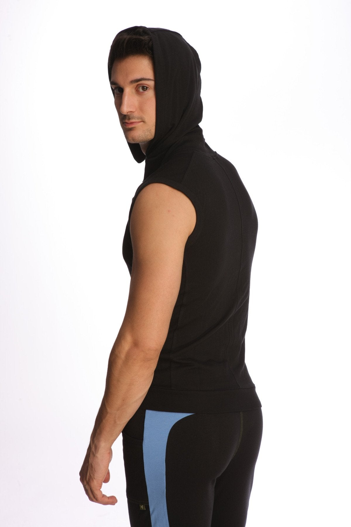 Black sleeveless yoga hoodie with hood paired with pants featuring subtle blue side paneling shown from the back