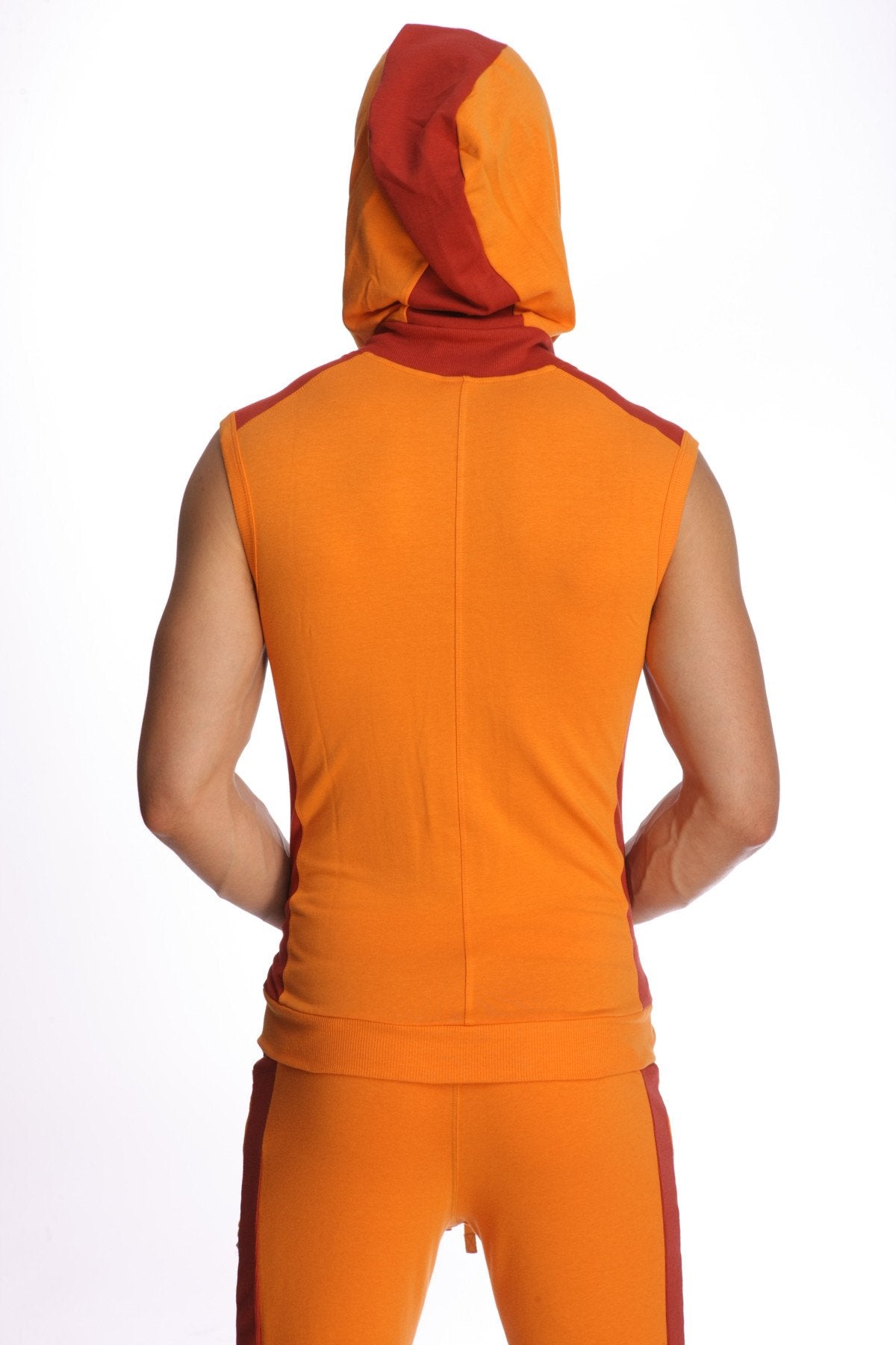 Sleeveless yoga hoodie in sun orange with a snug fit and bold orange red color contrast matching pants