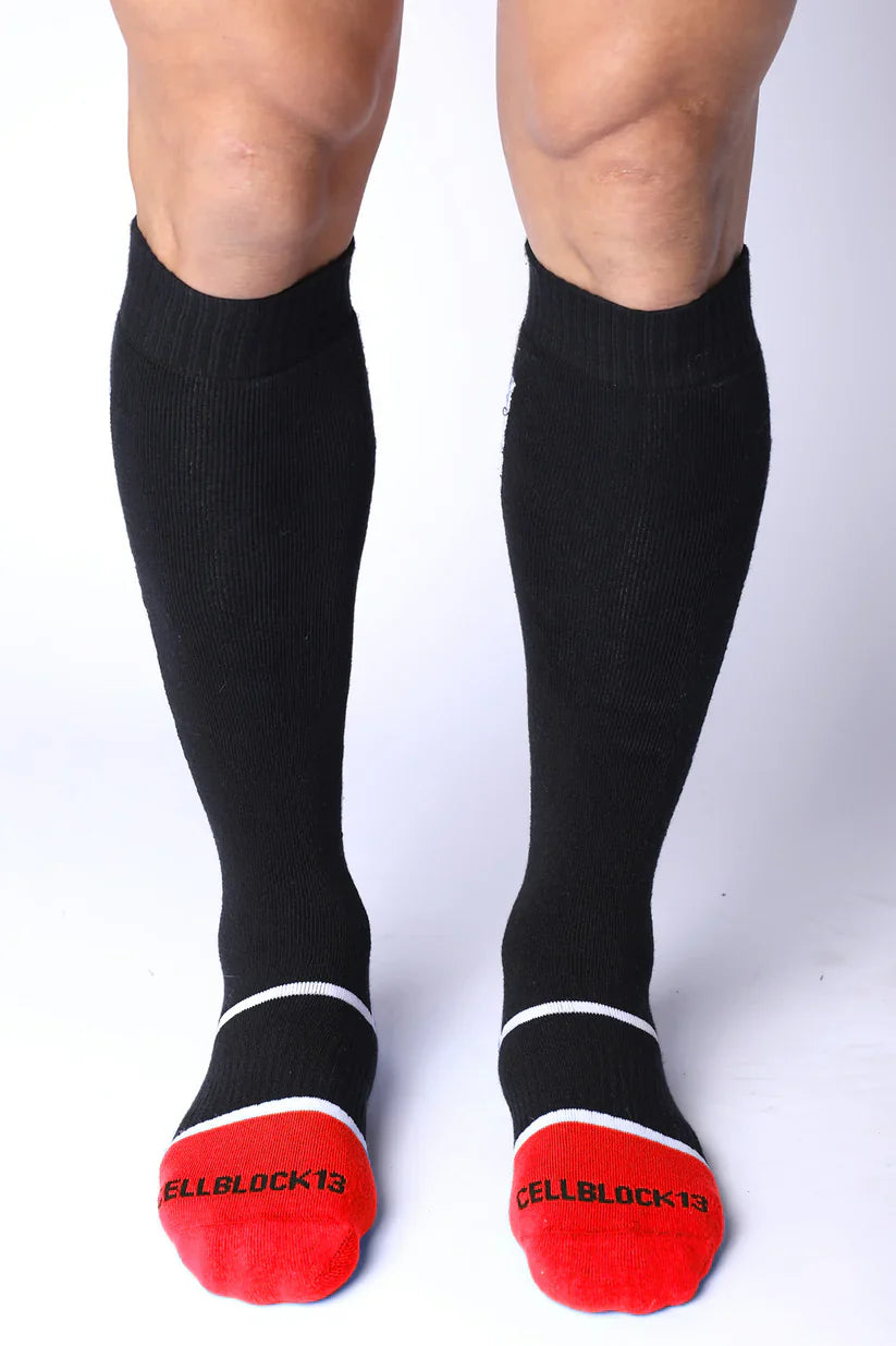 Take down knee high black compression socks with red toe caps white trim and cellblock13 logo on each foot