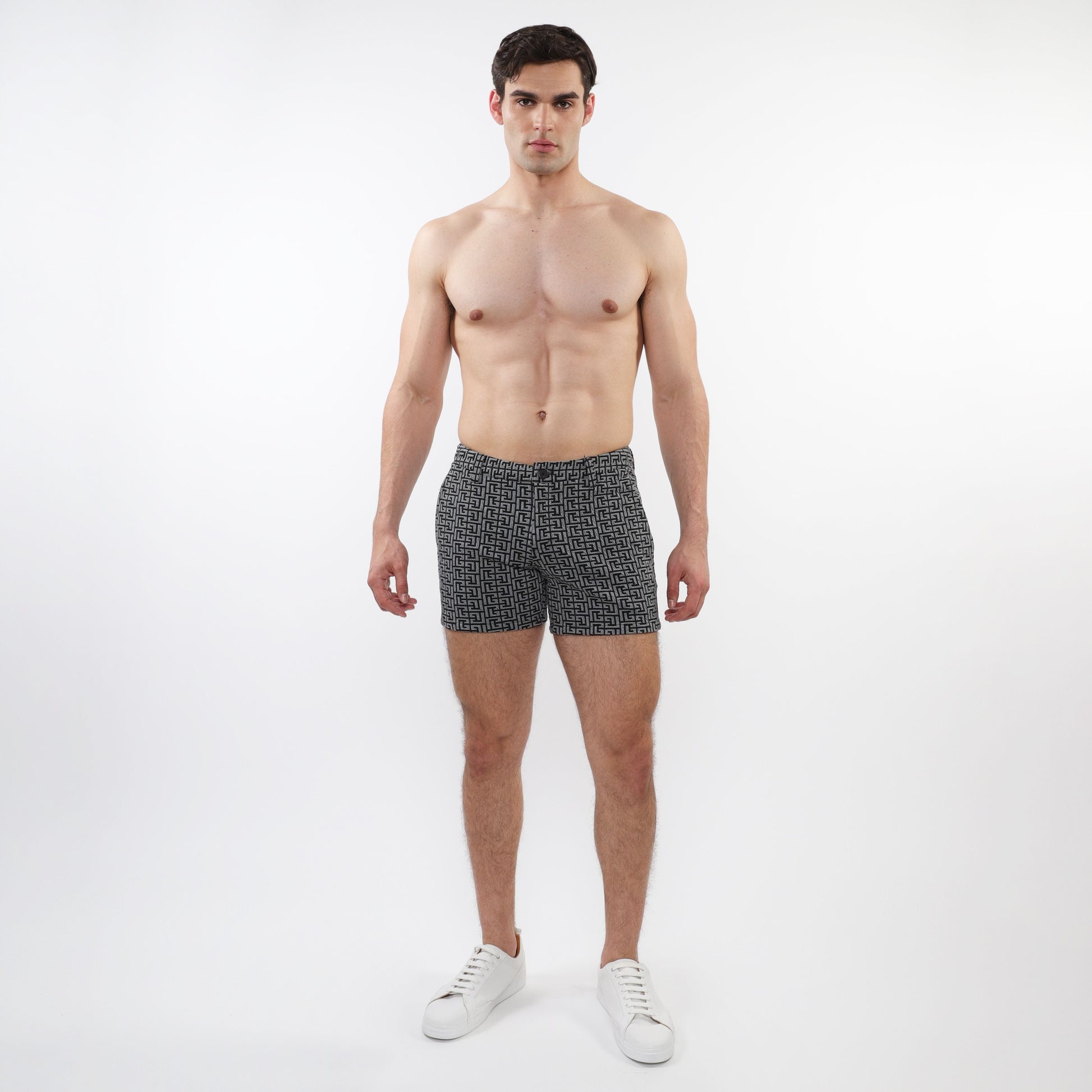 Textured jacquard stretch knit chino shorts with zip pockets in black and white geometric pattern for men